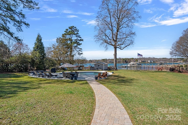 view of community with a water view and a yard