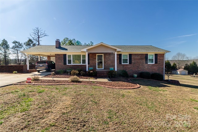 ranch-style house with a front yard, a chimney, a carport, concrete driveway, and brick siding