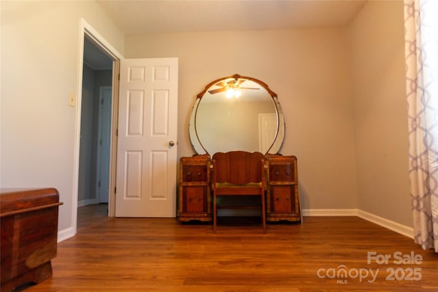 bedroom with wood finished floors and baseboards