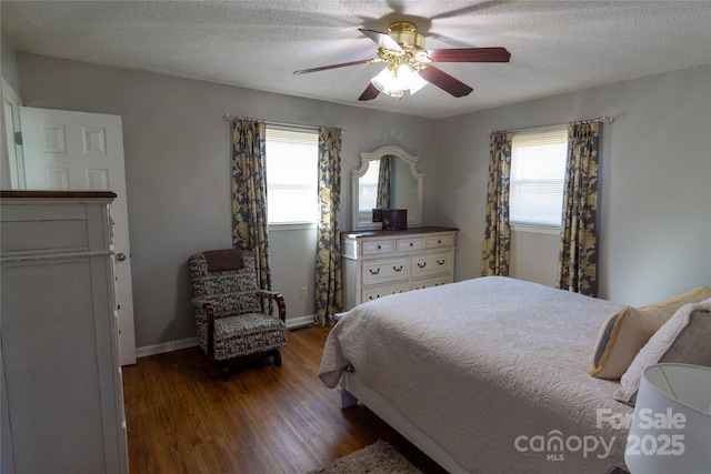 bedroom with baseboards, a textured ceiling, ceiling fan, and dark wood-style flooring