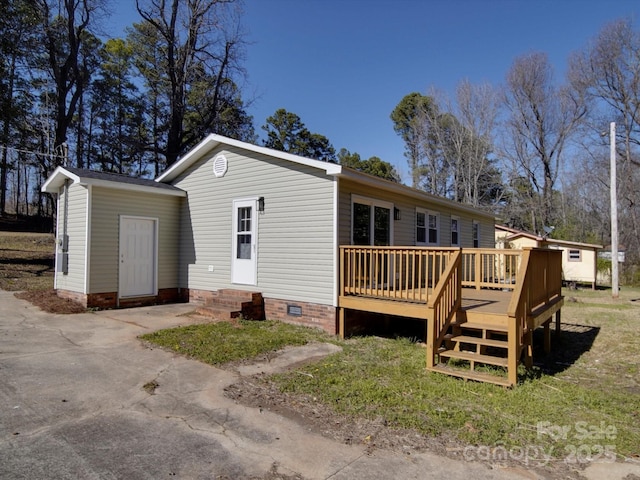 back of property featuring crawl space, a wooden deck, and entry steps