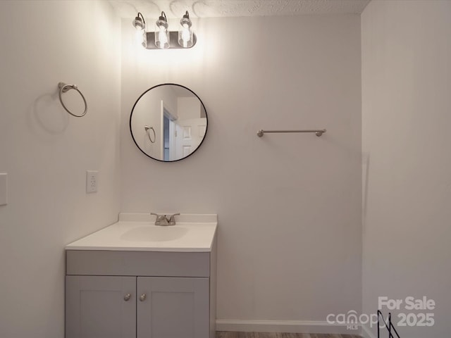 bathroom with a textured ceiling and vanity