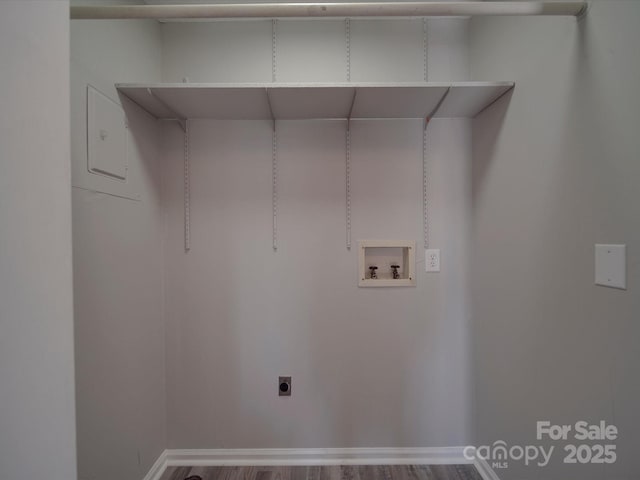 washroom with laundry area, washer hookup, wood finished floors, and baseboards