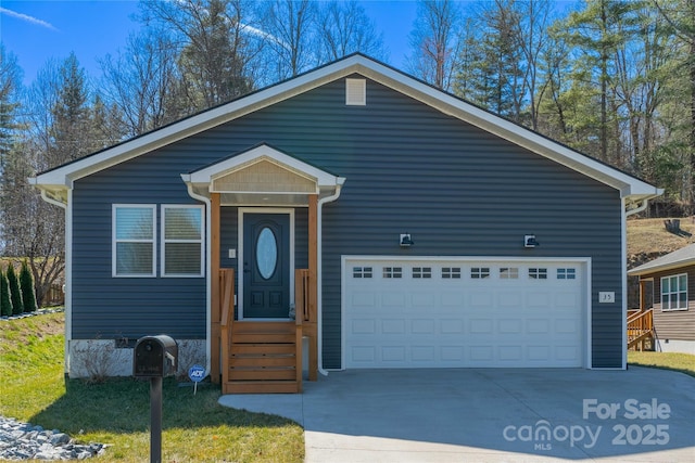 view of front of property with concrete driveway and an attached garage