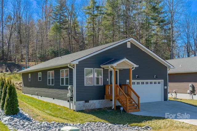 view of front of property featuring crawl space, driveway, and an attached garage