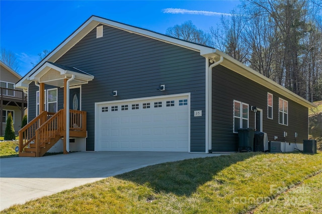 view of property exterior with driveway, an attached garage, cooling unit, and a yard