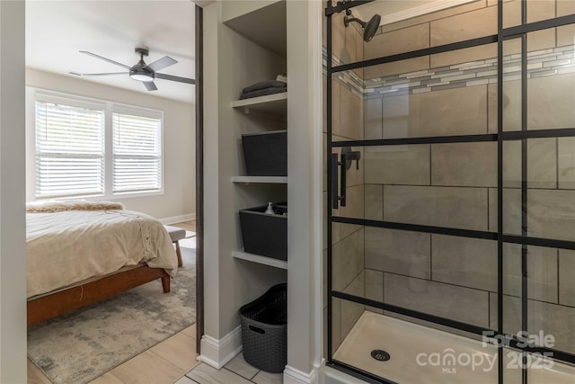 ensuite bathroom with ceiling fan, a stall shower, connected bathroom, and built in features