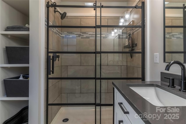 bathroom with a shower stall and vanity