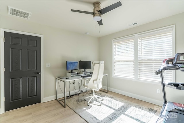 office with ceiling fan, wood finished floors, visible vents, and baseboards