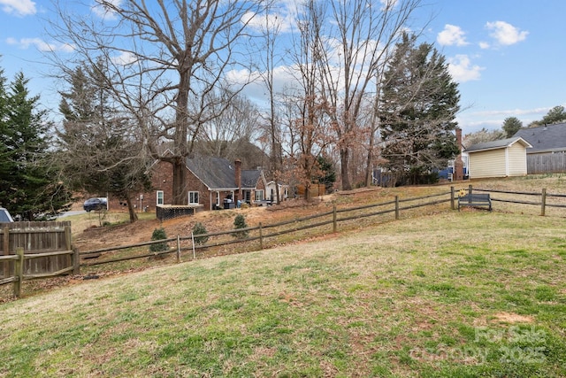 view of yard featuring fence private yard and an outdoor structure