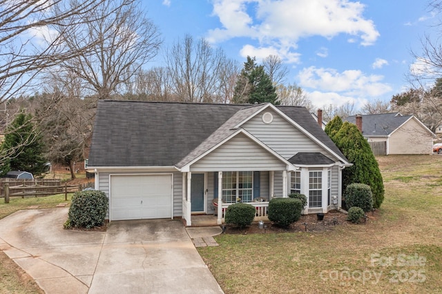 view of front of property with concrete driveway, an attached garage, covered porch, fence, and a front yard