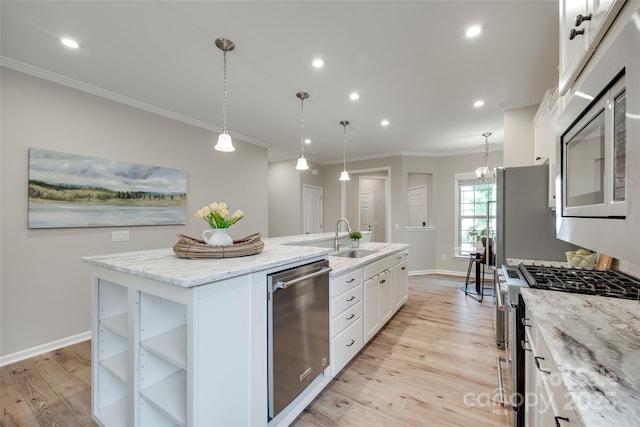 4521 Middlebury Ln, Fort Mill, SC 29715 - kitchen with stainless steel appliances, an island with sink, light wood finished floors, white cabinetry, and crown molding