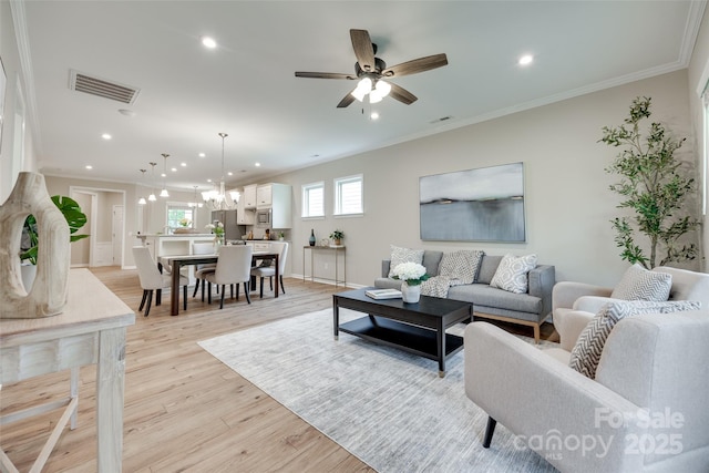 4521 Middlebury Ln, Fort Mill, SC 29715 - living area with recessed lighting, a chandelier, light wood-style floors, a ceiling fan, and ornamental molding
