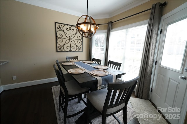 dining area featuring ornamental molding, light wood-style floors, baseboards, and an inviting chandelier