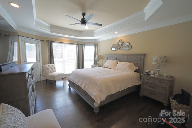 bedroom with dark wood-style floors, a tray ceiling, crown molding, recessed lighting, and ceiling fan