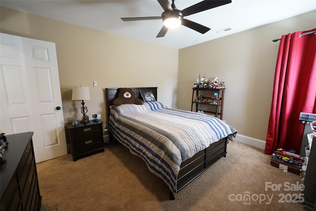 carpeted bedroom featuring baseboards, visible vents, and a ceiling fan