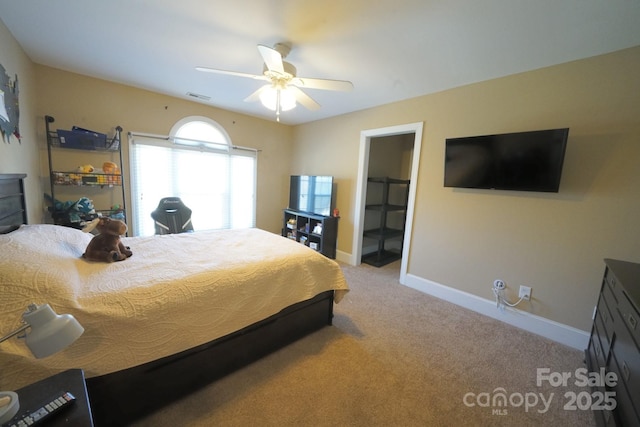 bedroom with visible vents, baseboards, ceiling fan, carpet, and a spacious closet