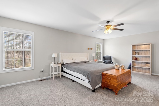 carpeted bedroom with ceiling fan and baseboards