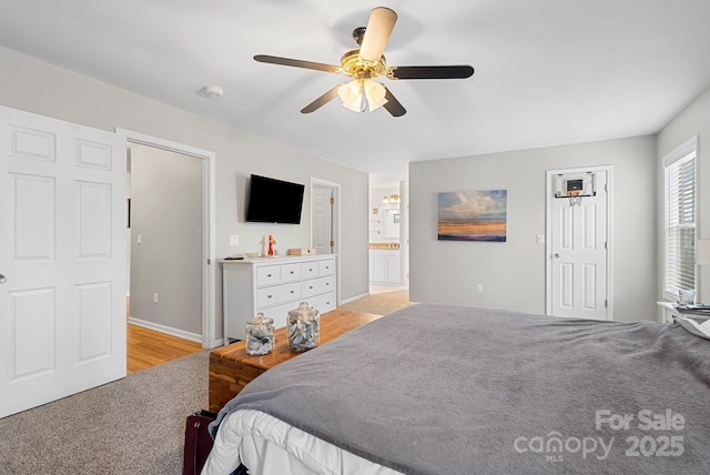 bedroom with ensuite bath and ceiling fan