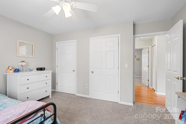 bedroom with ceiling fan, baseboards, and carpet flooring