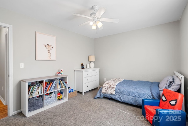 carpeted bedroom with baseboards and a ceiling fan