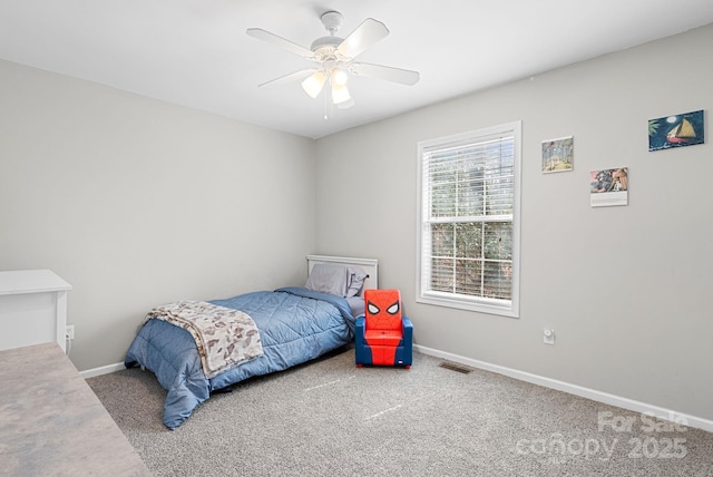 carpeted bedroom with a ceiling fan, visible vents, and baseboards