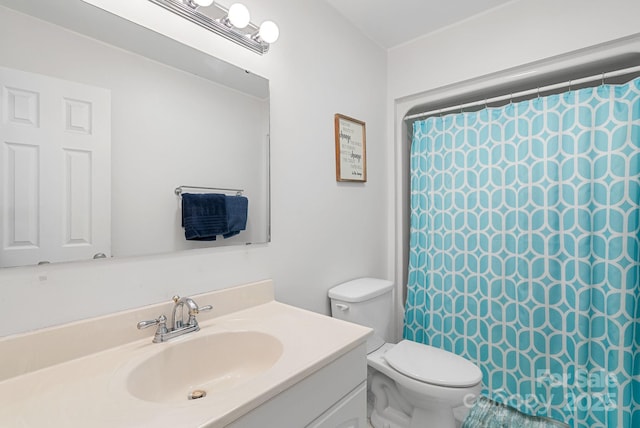 bathroom with toilet, curtained shower, and vanity