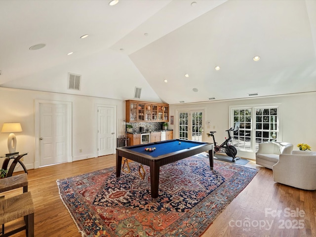 playroom featuring light wood finished floors, visible vents, bar area, and french doors