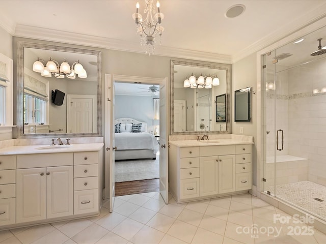 ensuite bathroom with a shower stall, ornamental molding, a sink, and ensuite bathroom