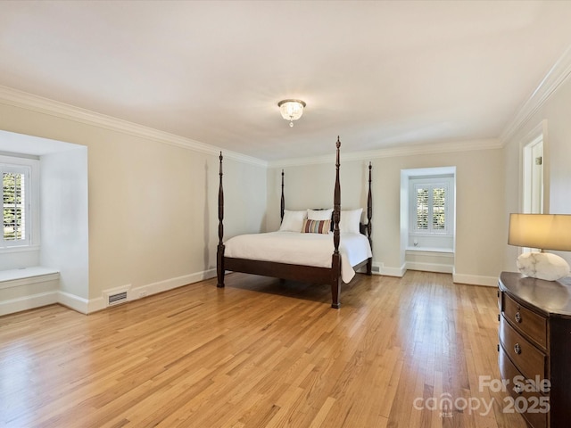 bedroom with ornamental molding, light wood-style flooring, multiple windows, and visible vents