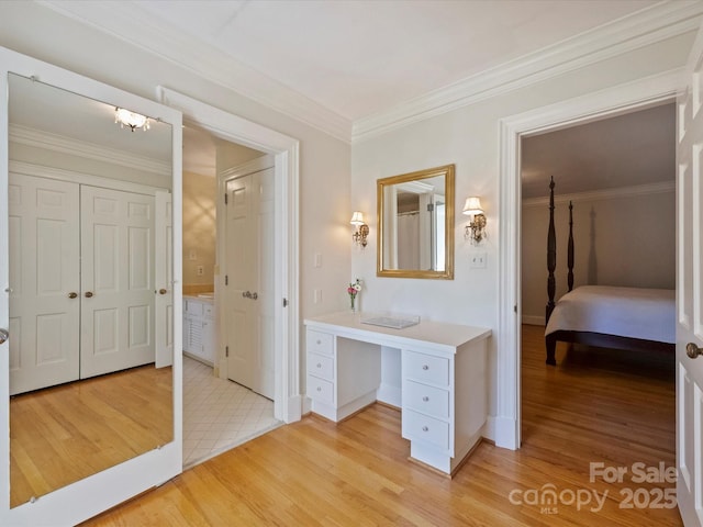 bathroom featuring crown molding, vanity, and wood finished floors