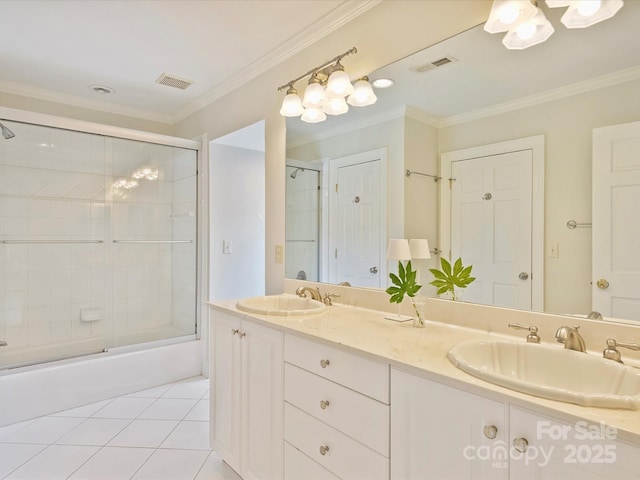 full bath with tile patterned flooring, crown molding, visible vents, and a sink