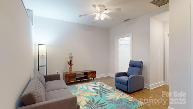 living area featuring ceiling fan, visible vents, and baseboards