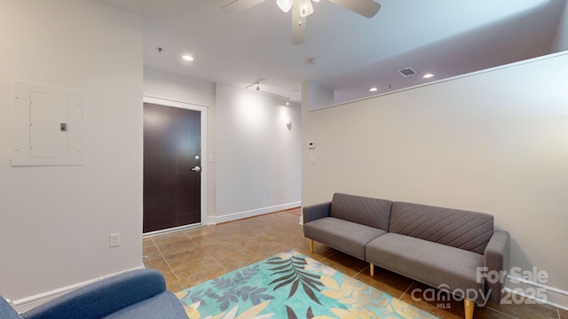 tiled living area with recessed lighting, visible vents, ceiling fan, electric panel, and baseboards