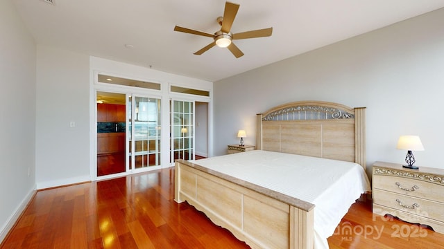 bedroom featuring ceiling fan, baseboards, and wood finished floors