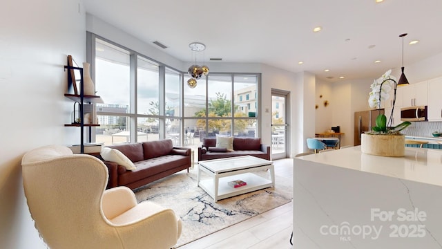 living room with recessed lighting and visible vents