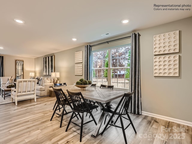 dining room featuring light wood-style floors, visible vents, baseboards, and recessed lighting