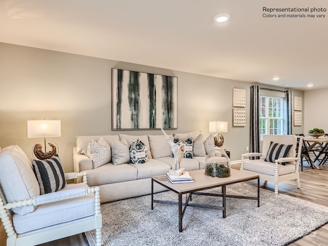 living room featuring baseboards, wood finished floors, and recessed lighting