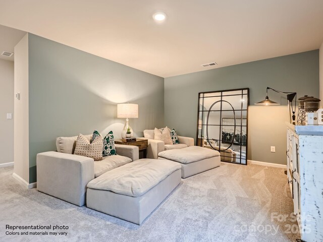 living room featuring baseboards, visible vents, and light colored carpet