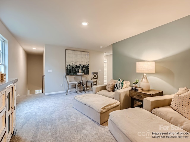 living area featuring carpet, baseboards, and recessed lighting