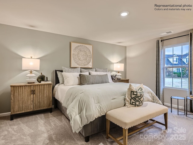 bedroom featuring baseboards, visible vents, and light colored carpet