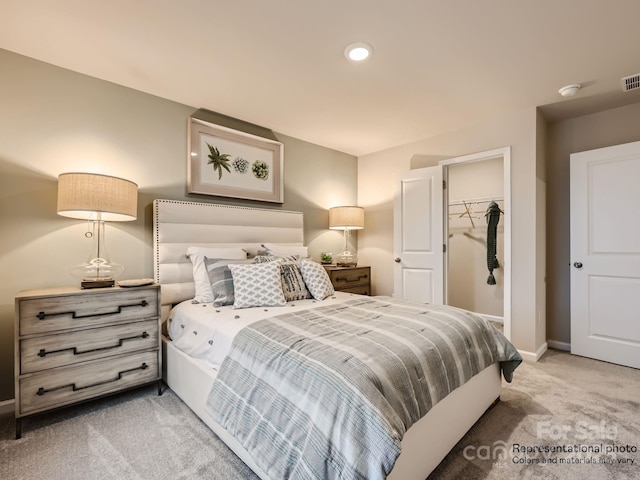 bedroom with light carpet, visible vents, baseboards, a spacious closet, and a closet