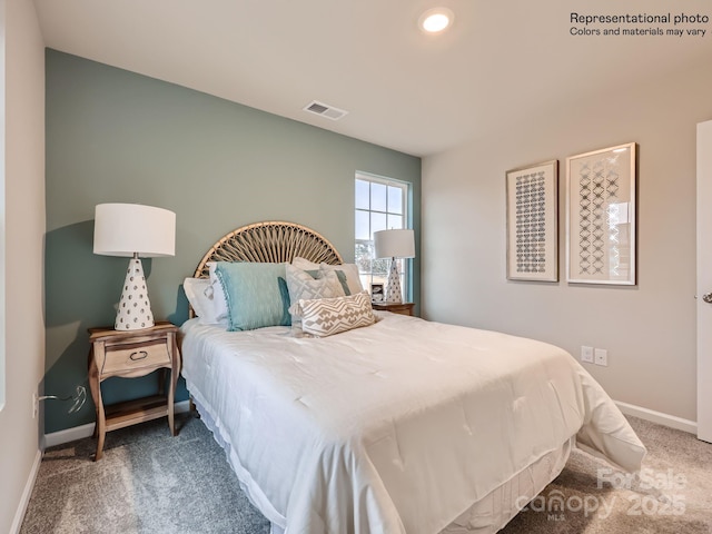 bedroom with carpet, visible vents, and baseboards