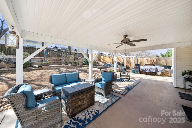 view of patio / terrace with an outdoor hangout area, a fenced backyard, and a ceiling fan