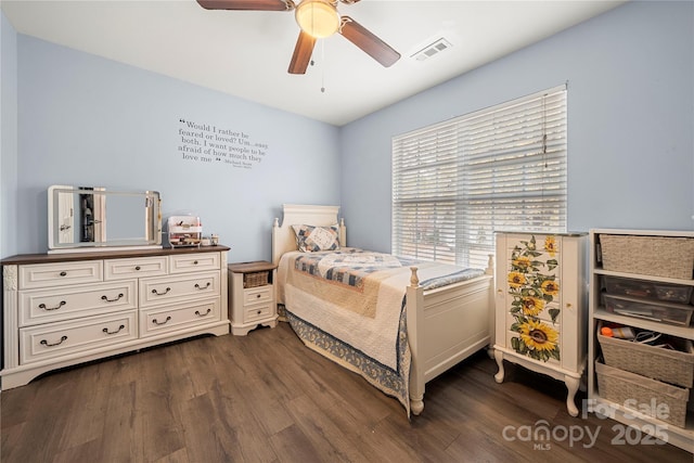 bedroom with visible vents, dark wood finished floors, and a ceiling fan