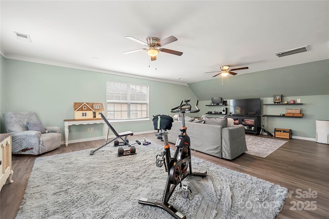 exercise room featuring visible vents, baseboards, and wood finished floors