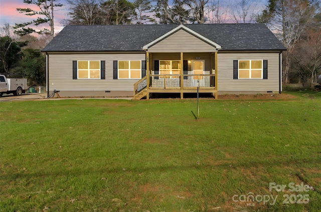 view of front facade featuring a porch, crawl space, roof with shingles, and a lawn