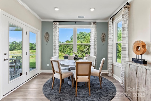 dining area featuring plenty of natural light, visible vents, and ornamental molding