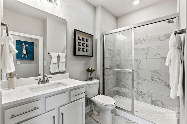 bathroom featuring a stall shower, toilet, marble finish floor, vanity, and recessed lighting