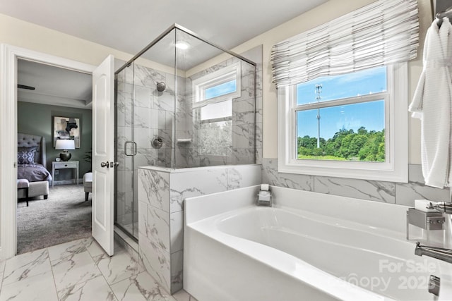 ensuite bathroom featuring a garden tub, connected bathroom, marble finish floor, and a wealth of natural light